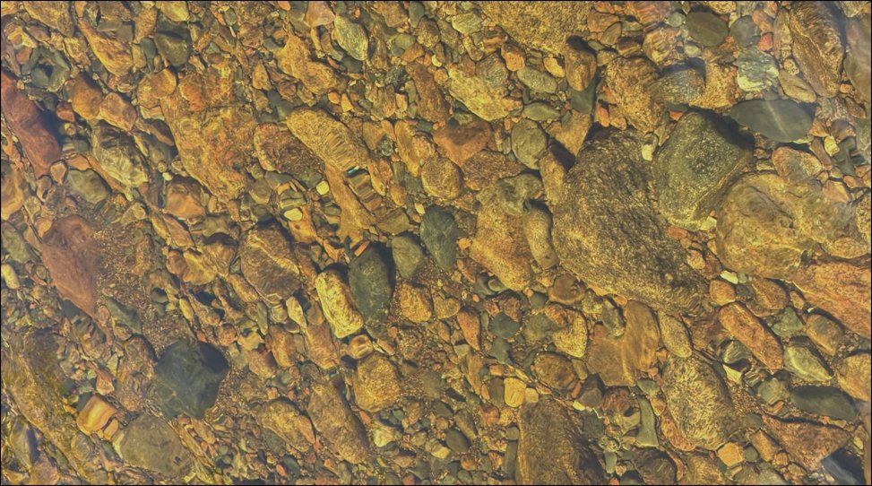Riverbed stones viewed through clear water