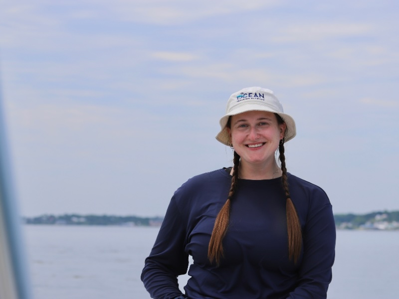 Morgan Piczak in the field, wearing an OTN bucket hat