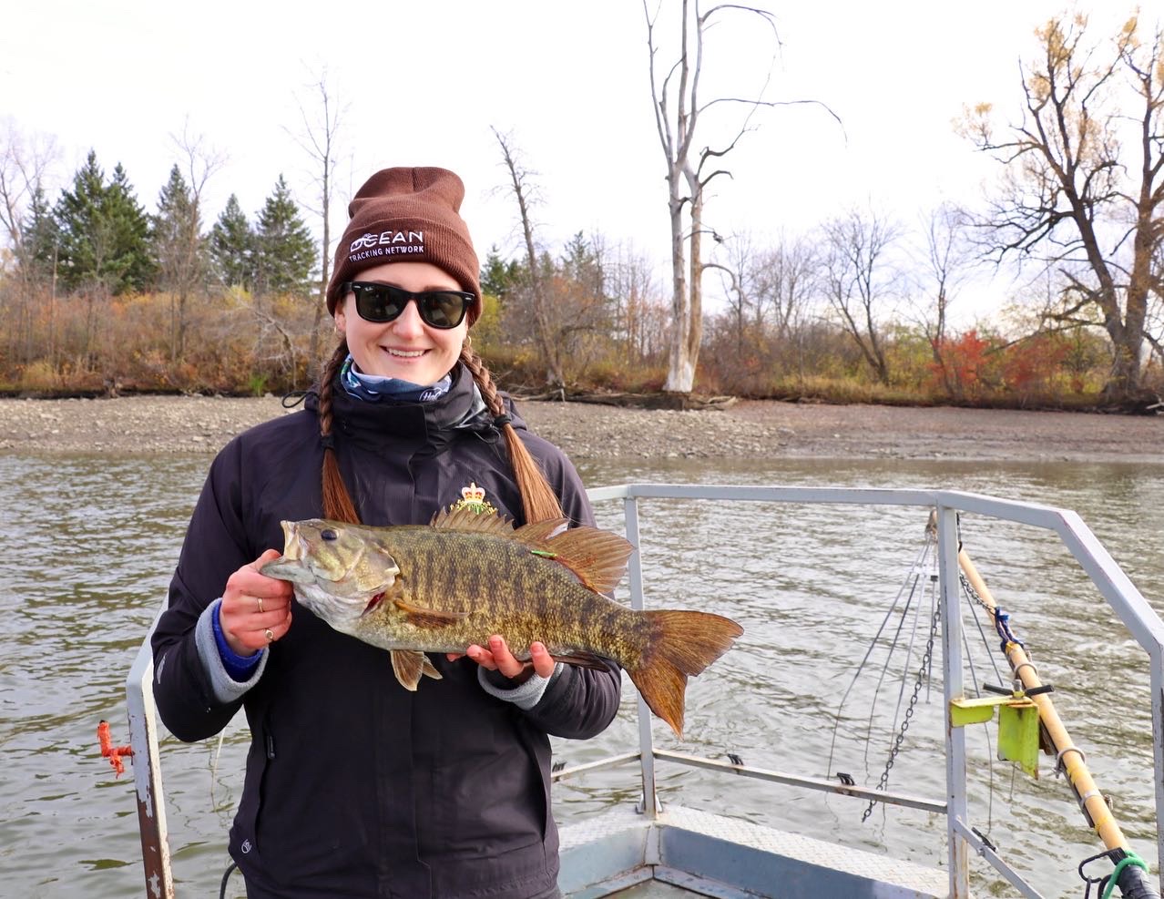 Morgan during PhD fieldwork holding a smallmouth bass